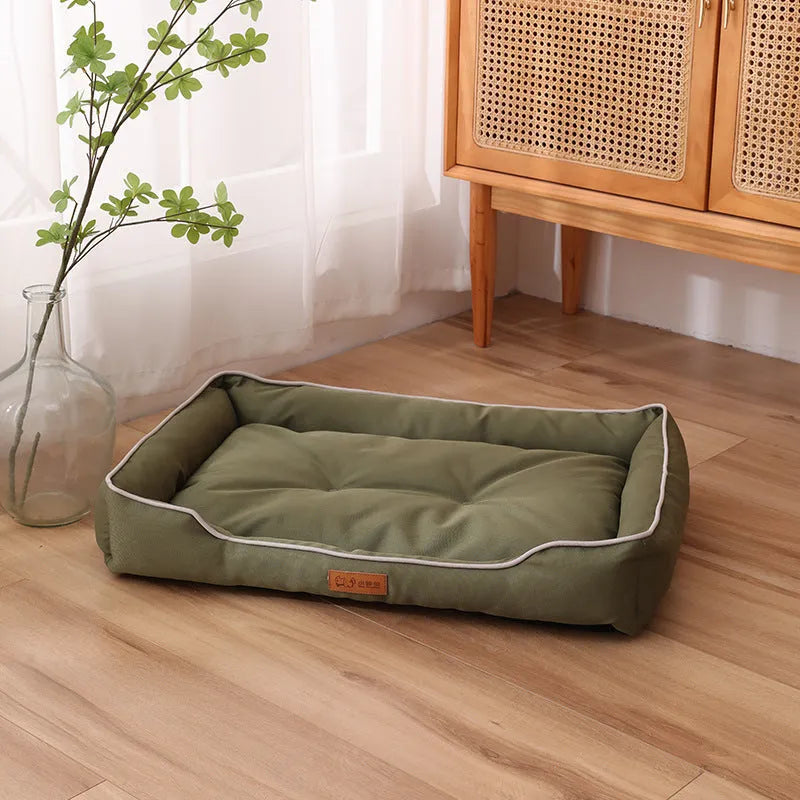 Grey waterproof dog sofa bed with a soft cushion, shown next to a sleeping golden retriever.