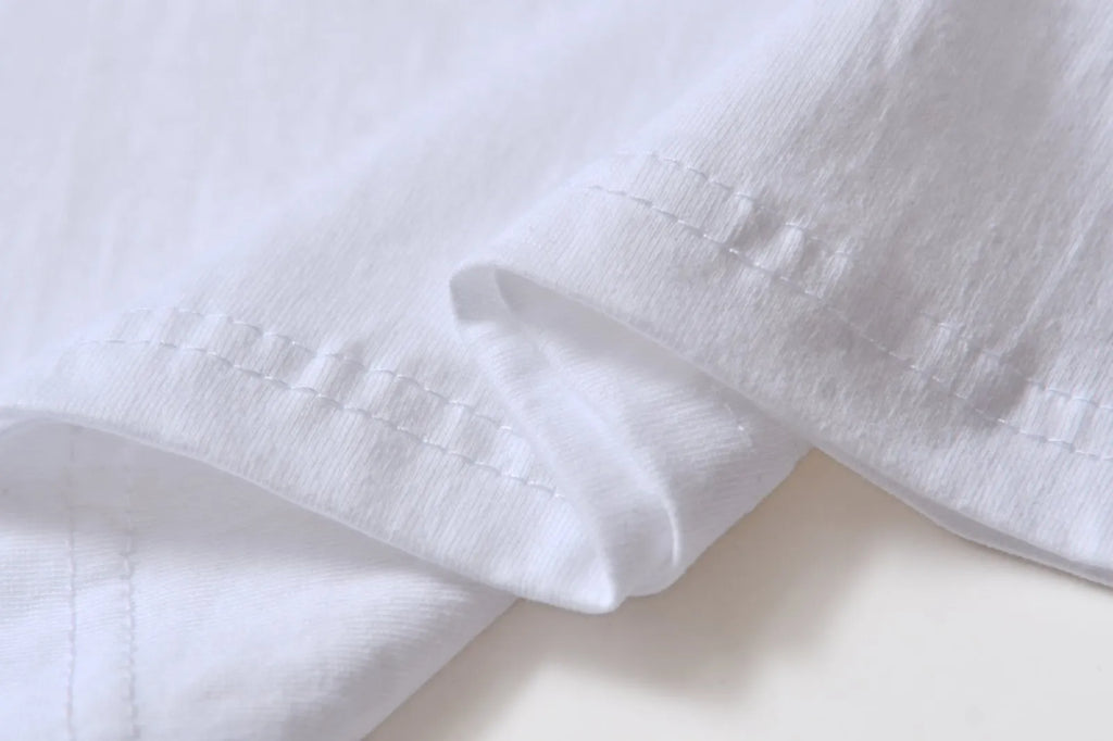 White patterned cotton pullover top with short sleeves on a hanger