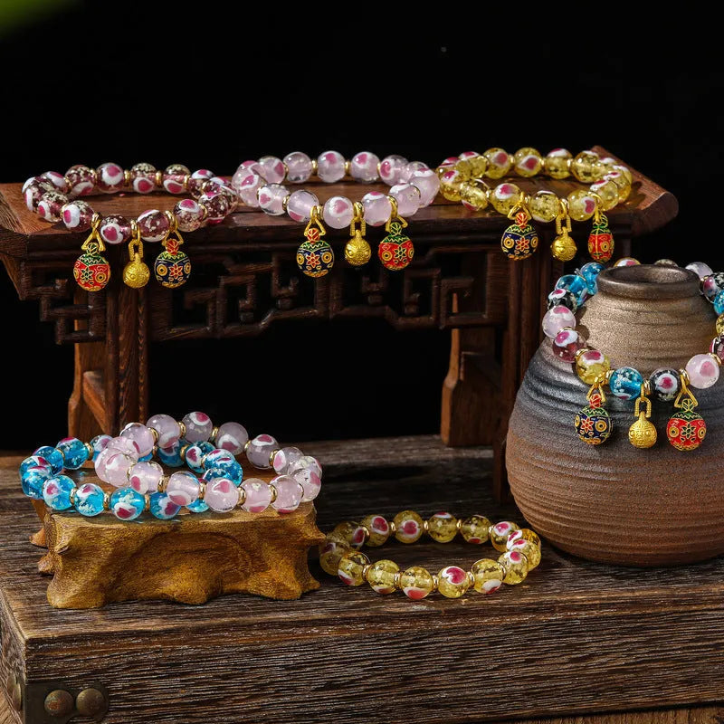Handmade glass bracelet with swallowing gold beast design and heart shape in various colours