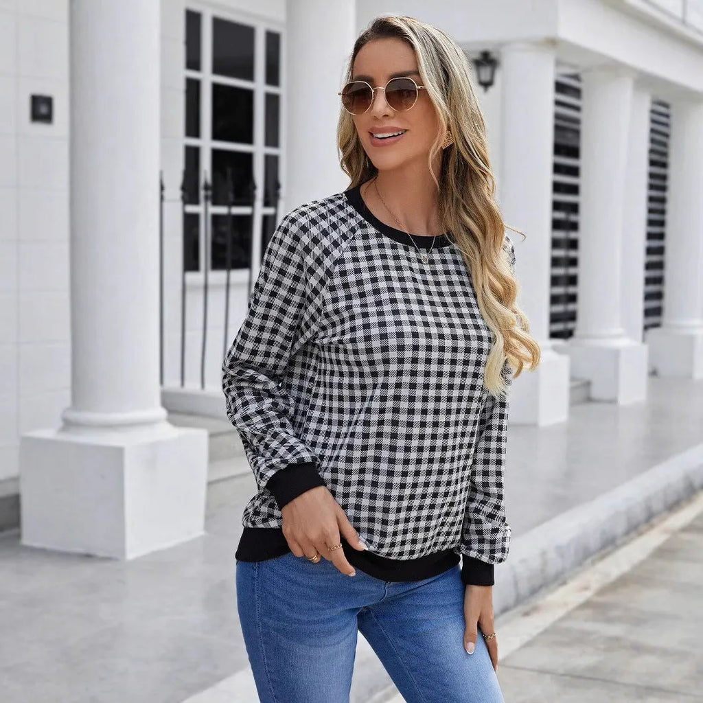 Black polyester pullover sweater with a plaid and printed stripe pattern, long sleeves.