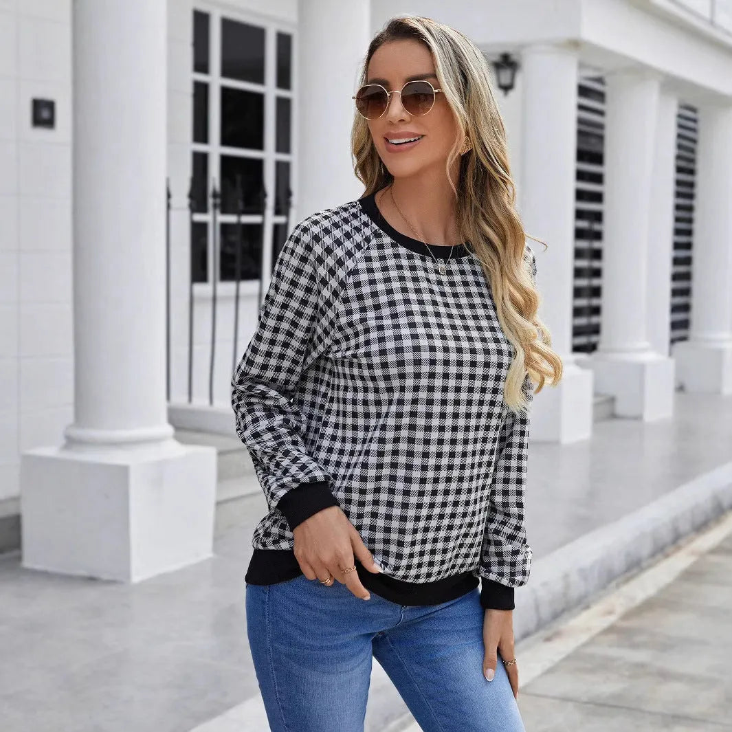 Black polyester pullover sweater with a plaid and printed stripe pattern, long sleeves.