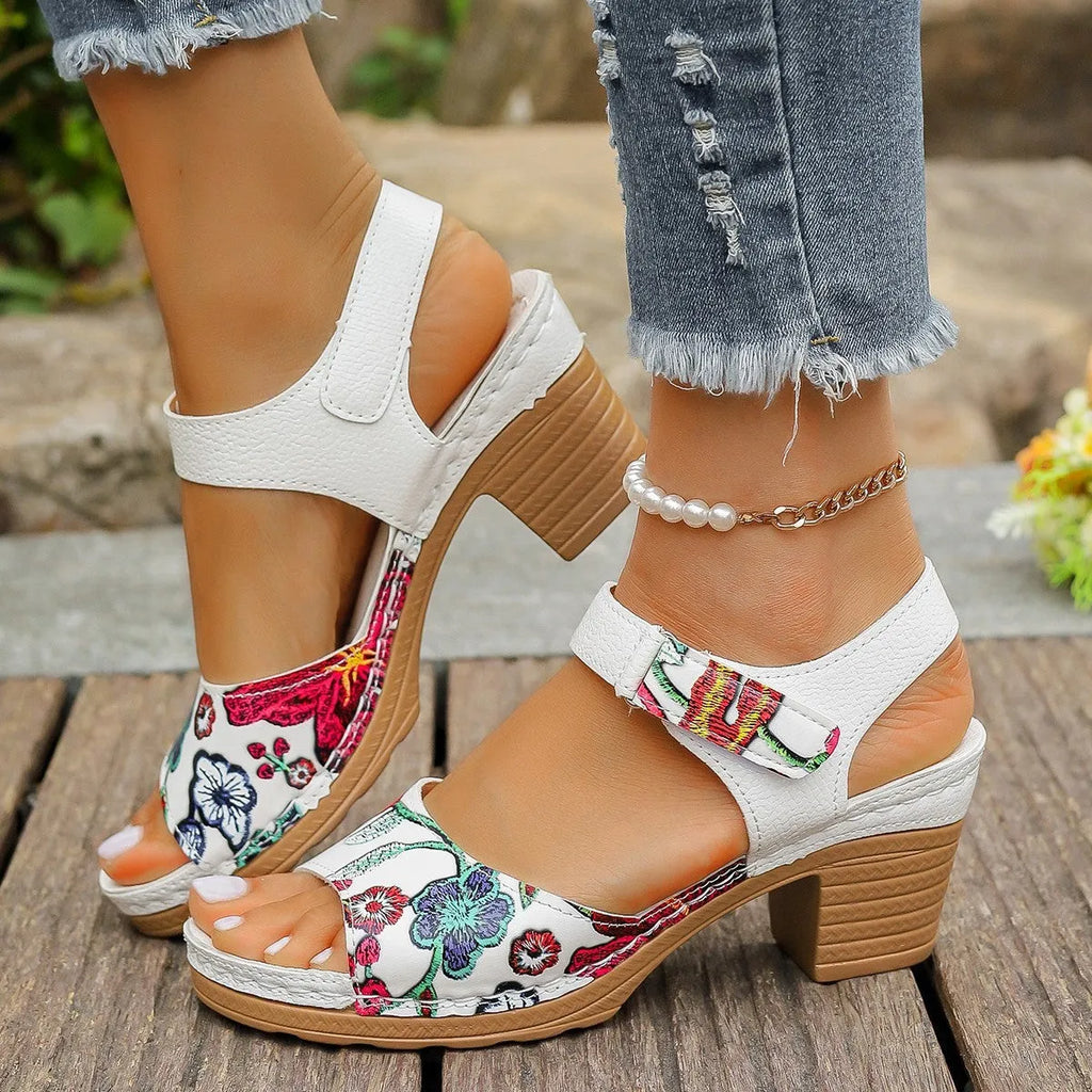 White women's high heel sandals with a Velcro strap buckle on a casual rubber sole.