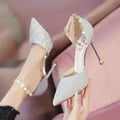 French high heel wedding shoes in silver with pointed toe, stiletto heel, and buckle closure on a clean background