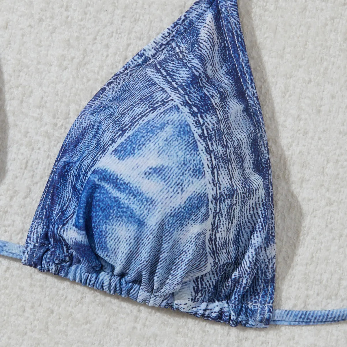 Denim blue women's bikini swimsuit with adjustable straps, shown as a complete set.
