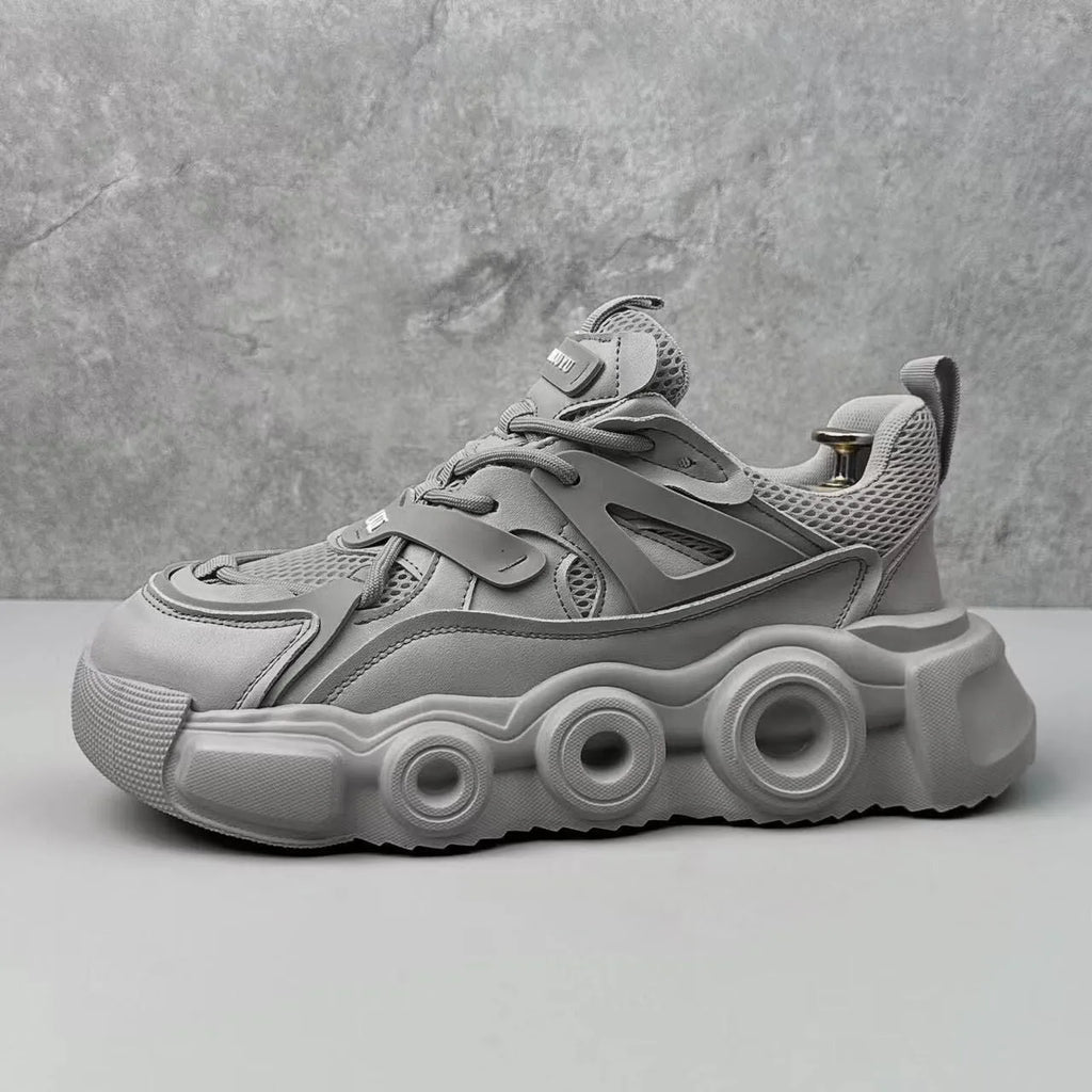 Men's low-top sneaker in grey with breathable mesh upper, thick rubber sole, round toe, and lace-up front.