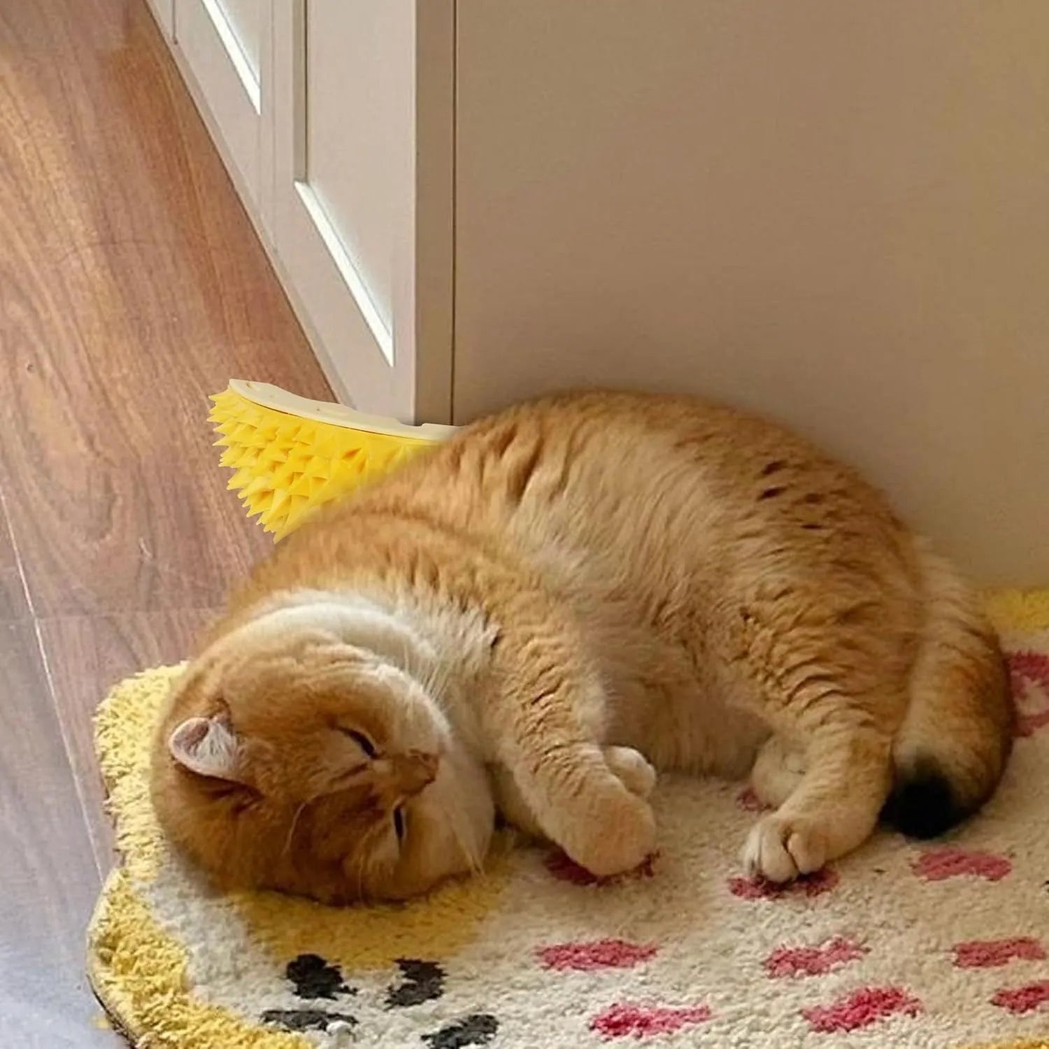 Yellow durian-shaped cat corner scratcher and massage comb mounted on a wall.