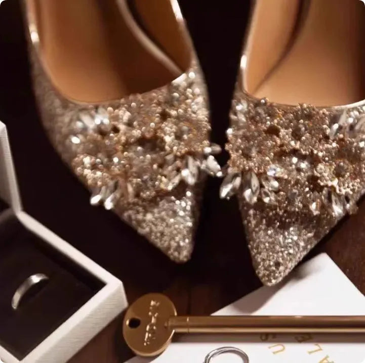 Champagne coloured women's wedding shoes with pointed toe, rhinestone details, and a fine heel.