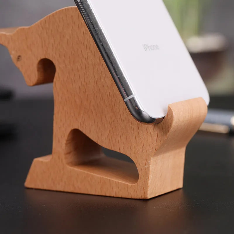 A decorative resin mobile phone stand holding a smartphone, shown in an animal design variant.