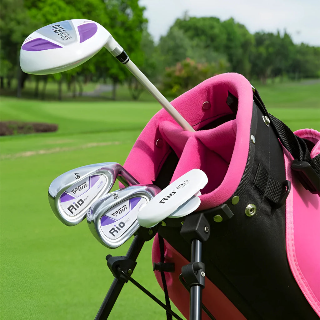 Children's golf club set featuring a forged aluminium driver, two iron poles, a putter, and a ball bag on a grassy field