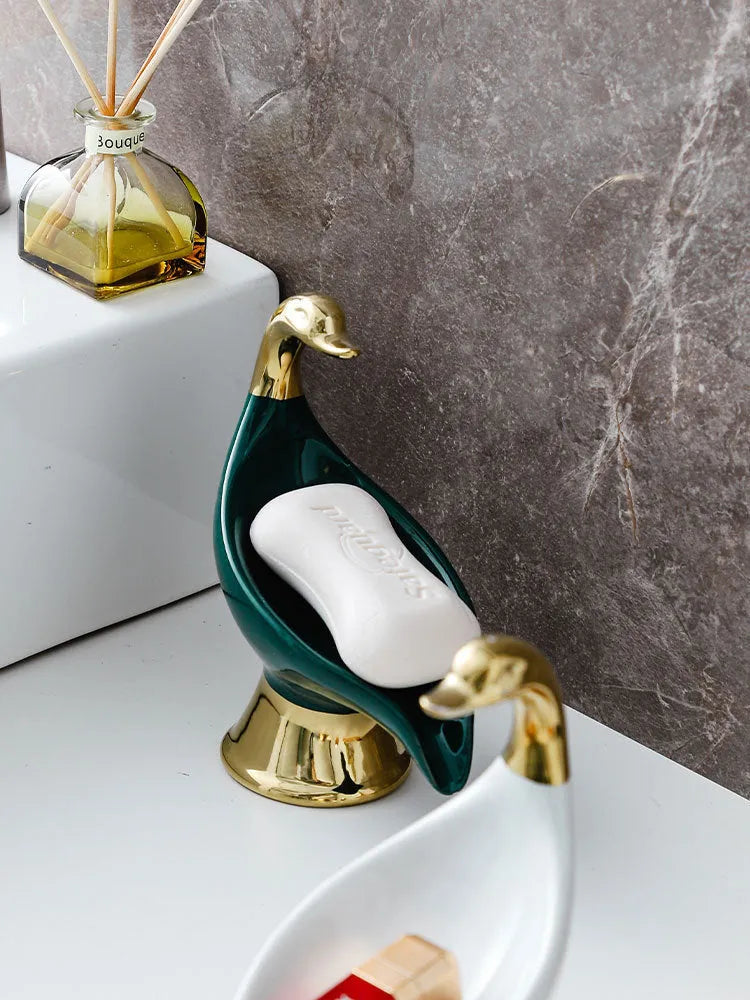 White ceramic swan soap dish with lid cover on bathroom countertop