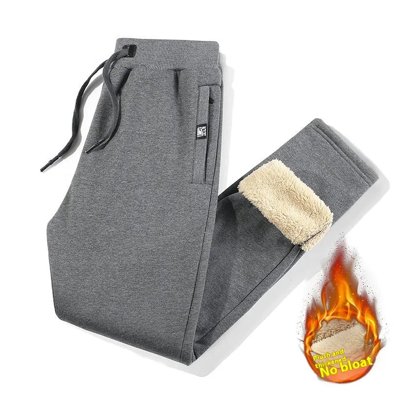 Men's grey fleece-lined cotton oversized track pants with a straight leg, laid flat.