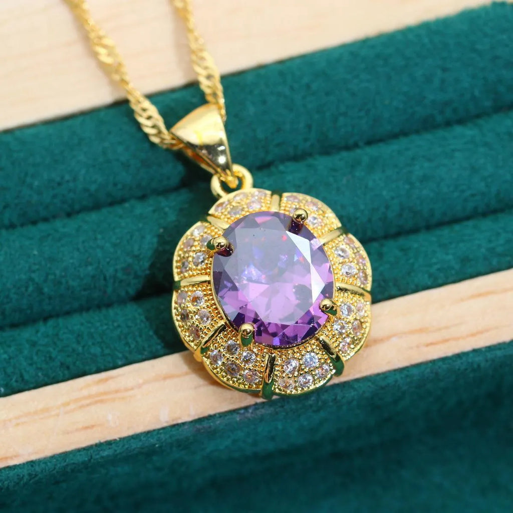 Gold plated jewellery set with coloured cubic zirconia stones, showing necklace, earrings, bracelet, and ring.
