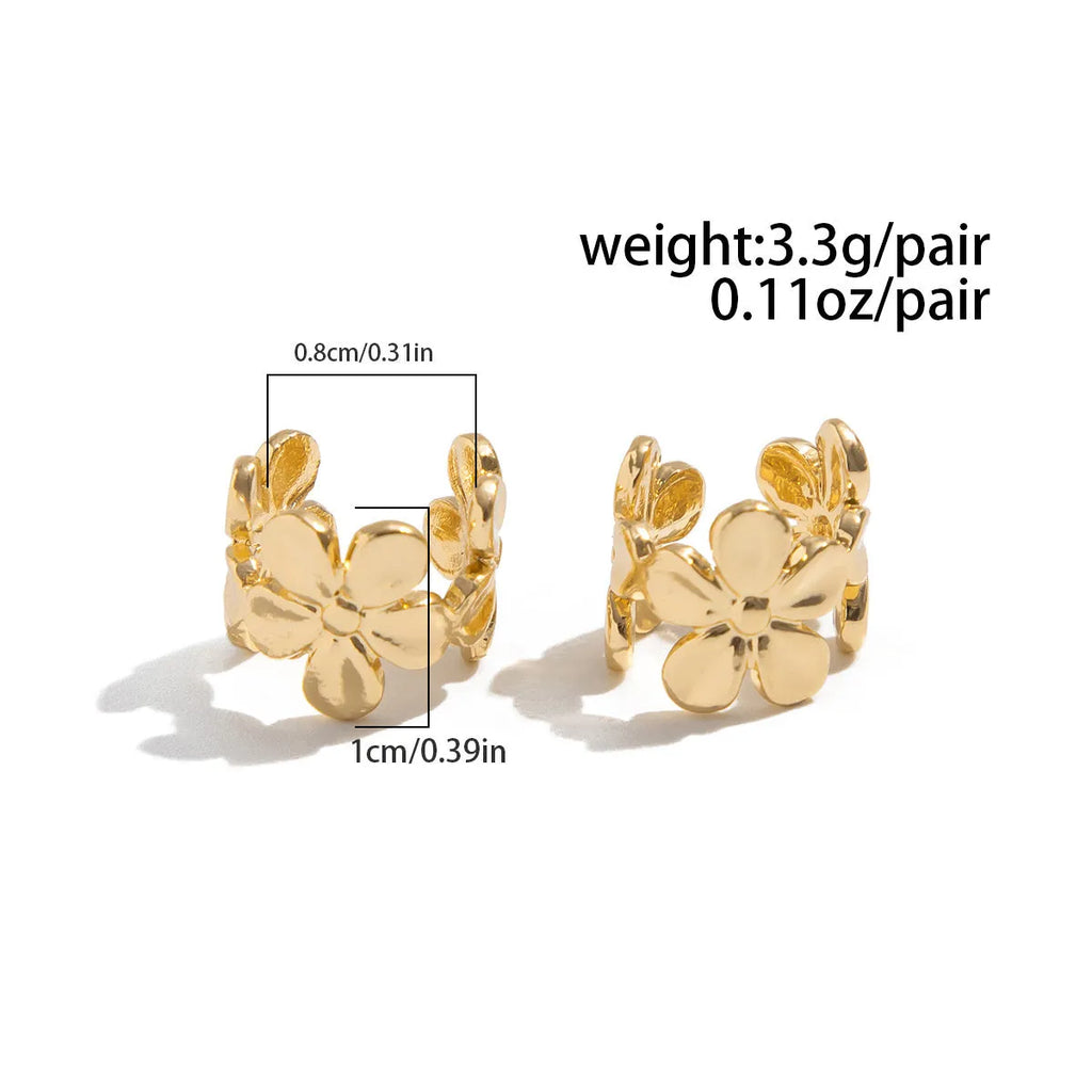 Gold-coloured alloy earrings with starfish and conch designs on a white background.