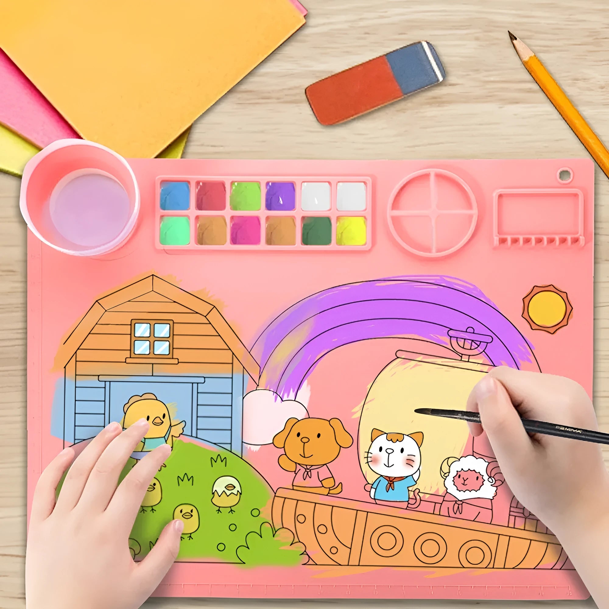 Light blue silicone painting mat measuring 50 by 40 cm on a wooden table