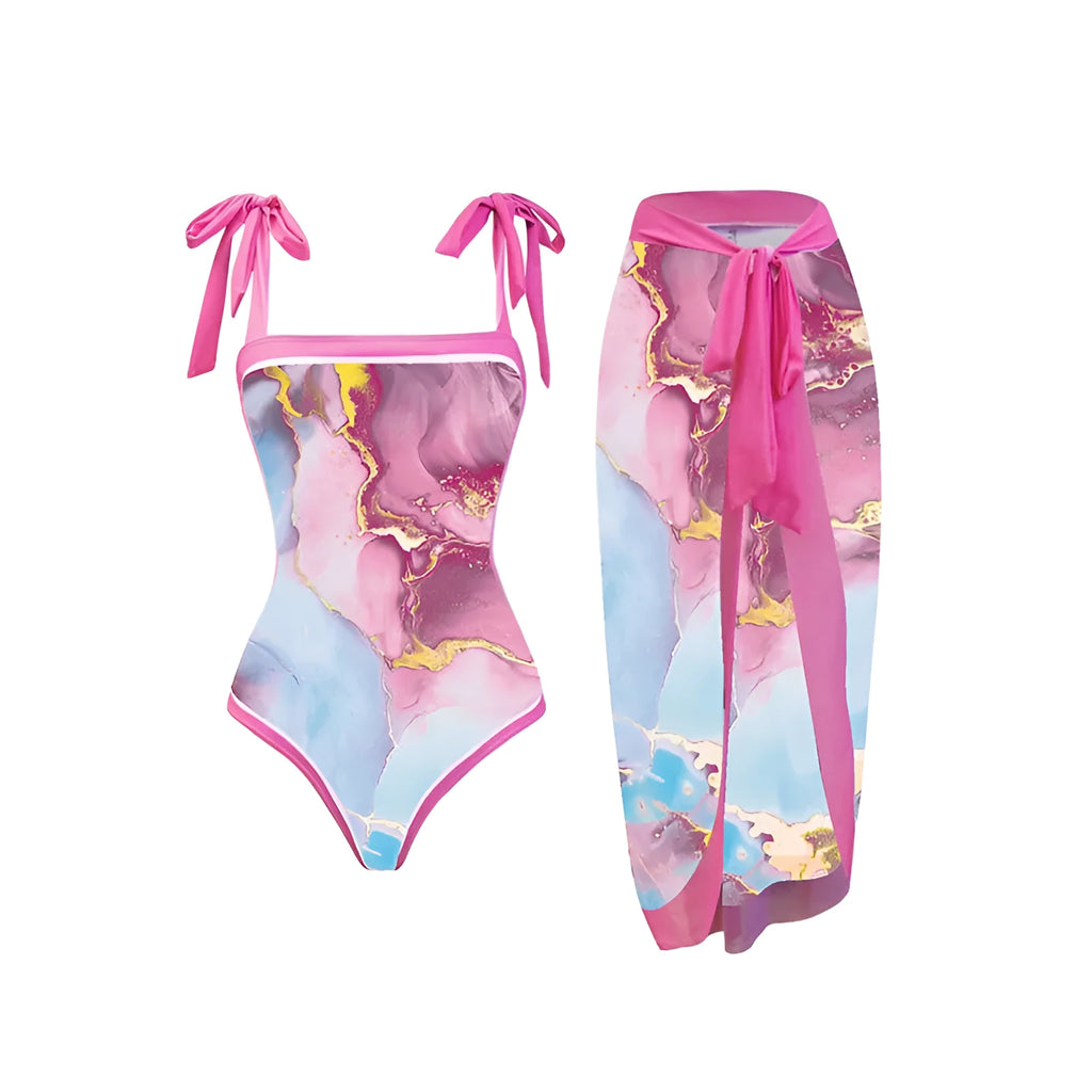 Pink printed women's one-piece swimsuit with a sheath silhouette and attached skirt.