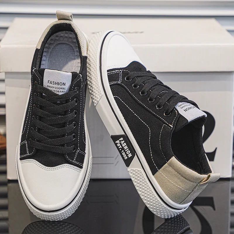 Men's low-top canvas shoes in blue with white sole and lace-up front, on a grey background.