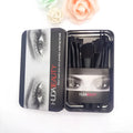 12 makeup brushes with corrugated silk nylon bristles and wooden handles in a black tin box on a flat surface.
