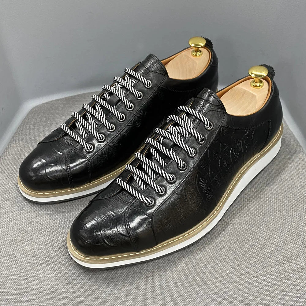 Men's low-top handmade shoes with an embossed pattern and front tie laces.