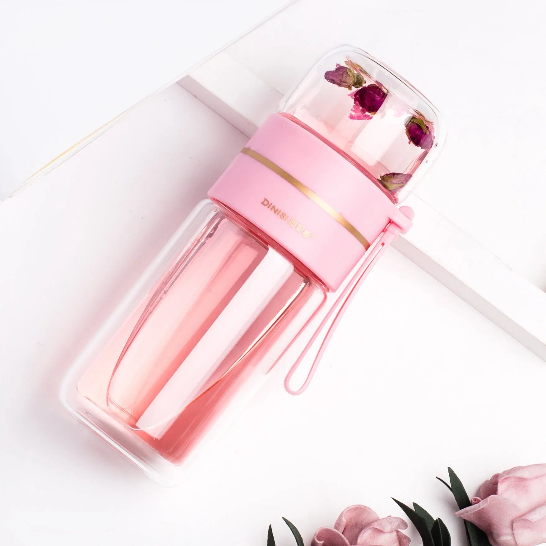 Glass water bottle with tea infuser filter showing double wall construction and portable rope