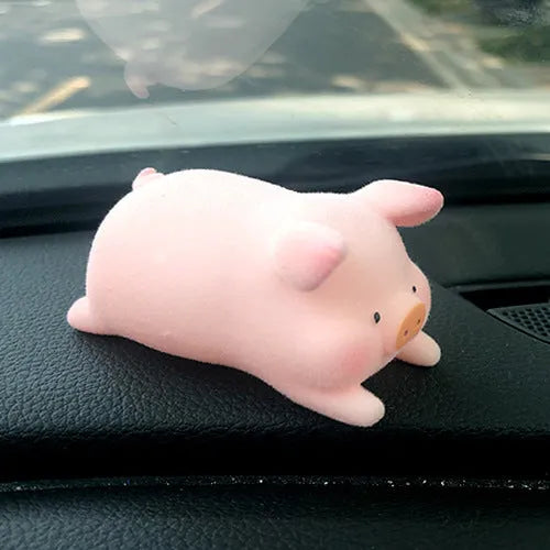 Glossy resin cartoon pig ornament for car dashboard decoration, shown in one of eight available character styles.