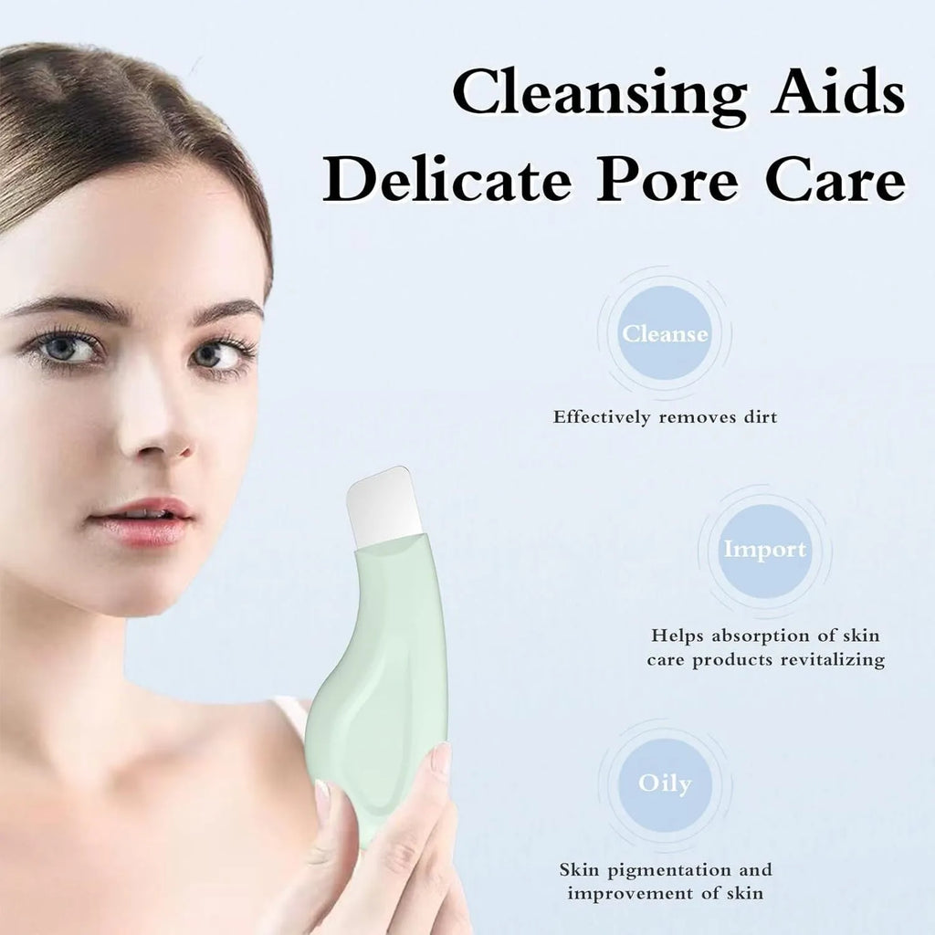 Stainless steel facial pore scraper tool with a green silicone non-slip handle on a white background.