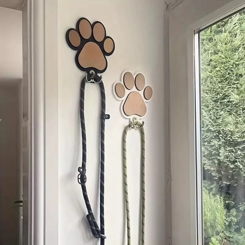 Wooden foot paw print wall hook in black on a white background, showing its shape and design.