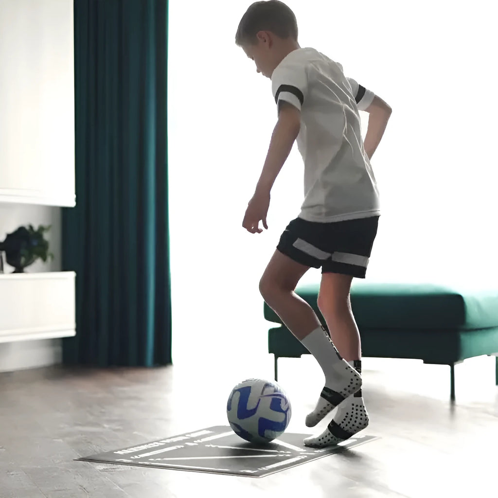 Black rectangular non-slip football training mat measuring 60 by 90 centimetres.