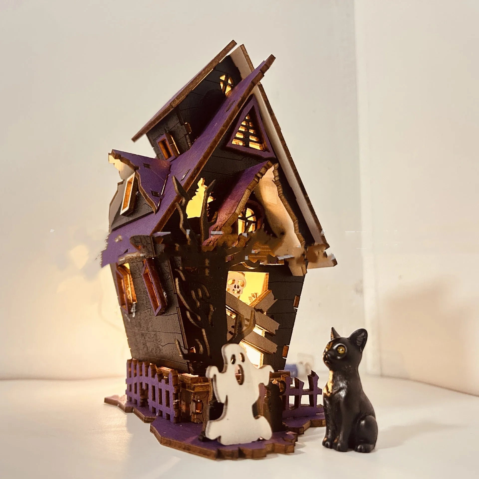 Wooden DIY glowing haunted house Halloween table decoration with luminous details