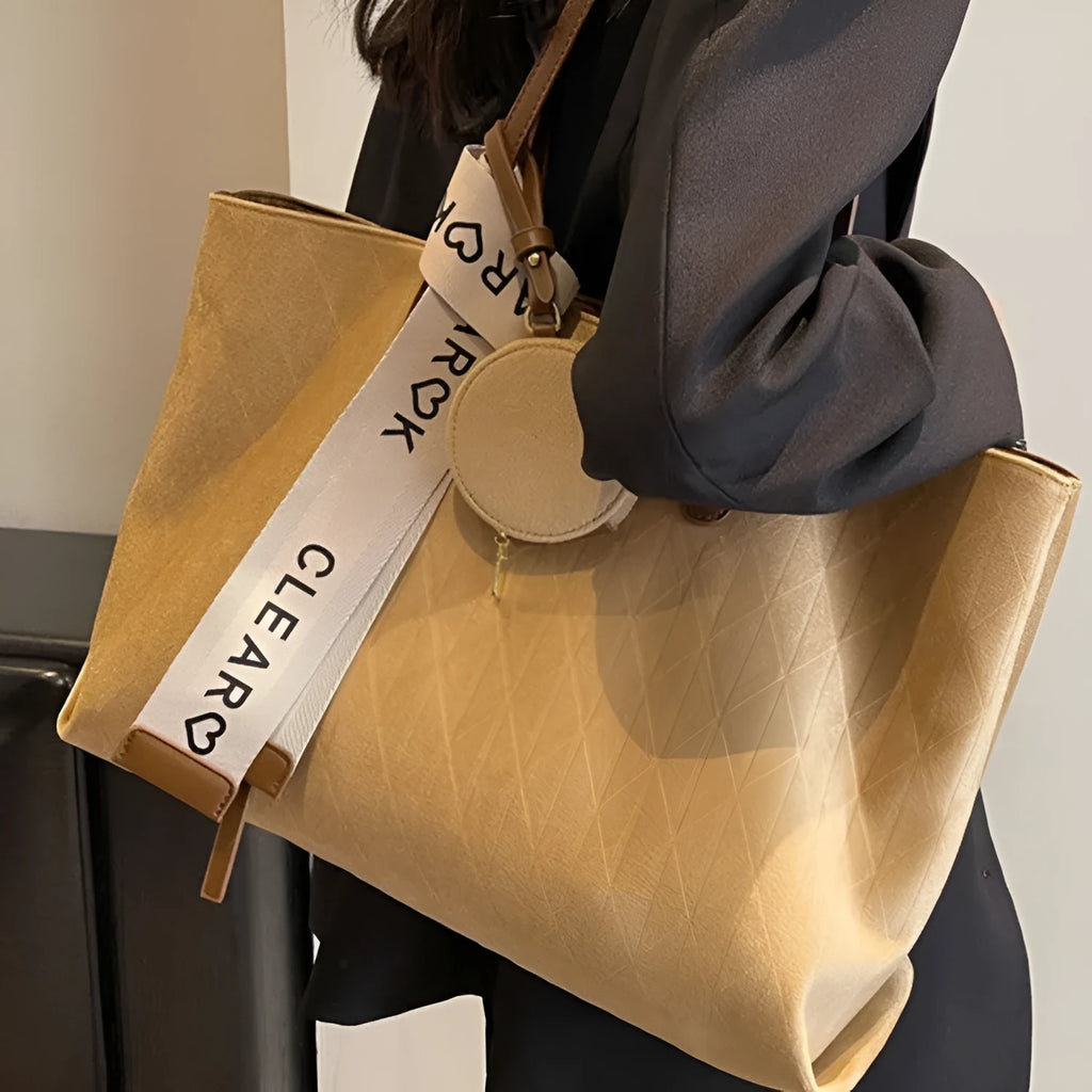 Large black polyester shoulder bag showing horizontal square shape and organisational pockets