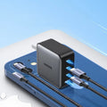 100W Gallium Nitride multi-port USB-C charger plug with attached cable on a grey background.