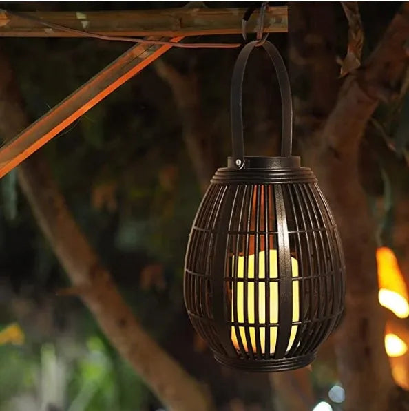 Oval rattan-style solar garden light in retro design for outdoor patio use.