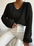 A woman wearing a solid colour long sleeve polyester pullover in a casual, loose fit.