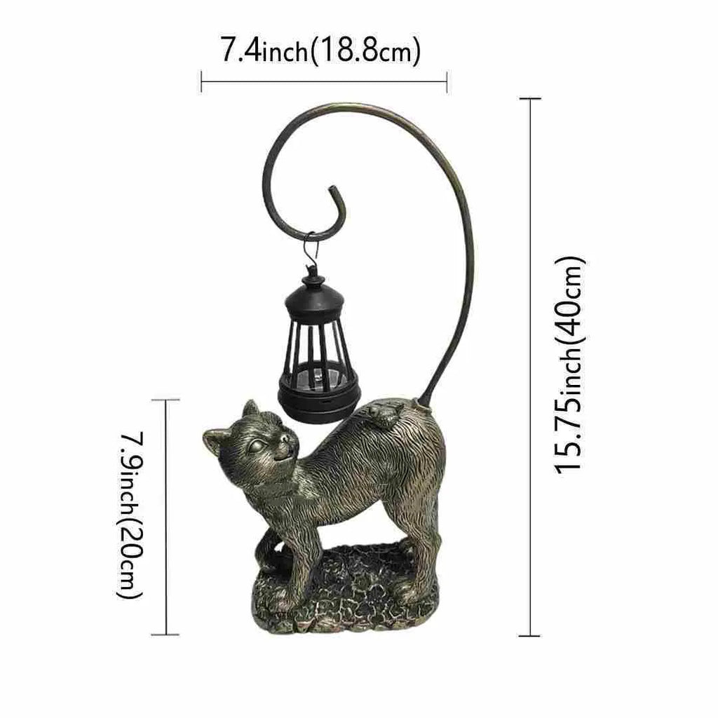 Bronze resin cat solar garden lamp on a garden path, outdoor decoration