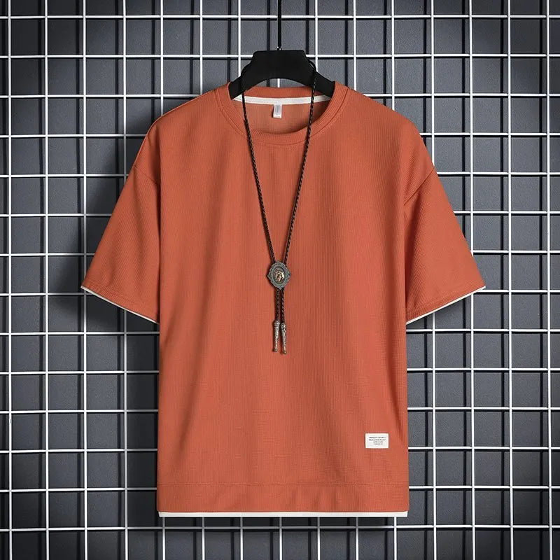 Half sleeve loose pullover top in polyester, available in seven colours and sizes M to 5XL