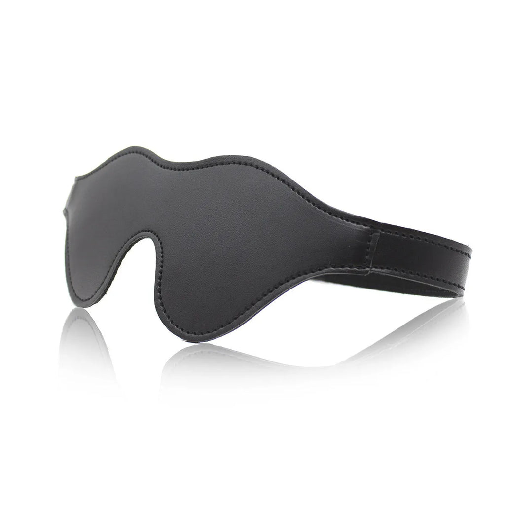 Women's black leather eye mask with 3D shape, Velcro strap, and metal rivet details.