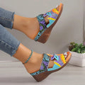 Colourful ethnic slope heel slippers for women with totem design on a cowhide upper.