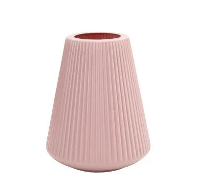 Colourful melamine plastic decorative flower vase, 16 cm by 20 cm, on a desktop.