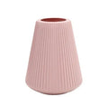 Colourful melamine plastic decorative flower vase, 16 cm by 20 cm, on a desktop.