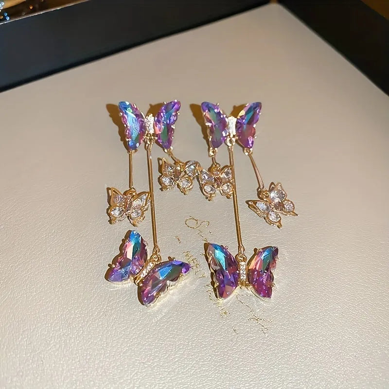 A pair of silver needle-blue purple butterfly tassel earrings with crystal flowers on a 4.5cm drop.