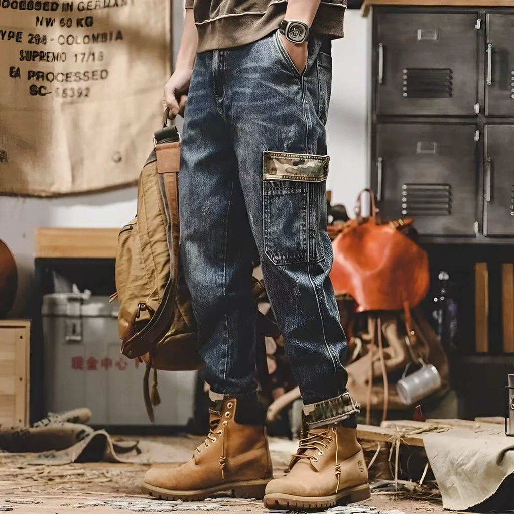 Men's loose blue denim cargo jeans with heavy distressed finish, mid waist, button fly