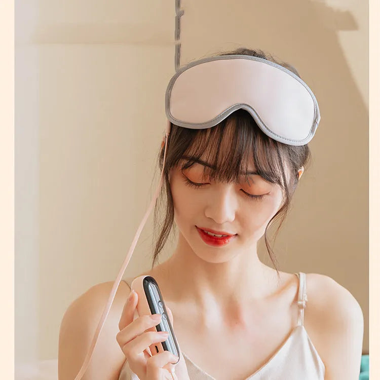 Green portable steam sleep massage goggles with suede shell on a grey background.