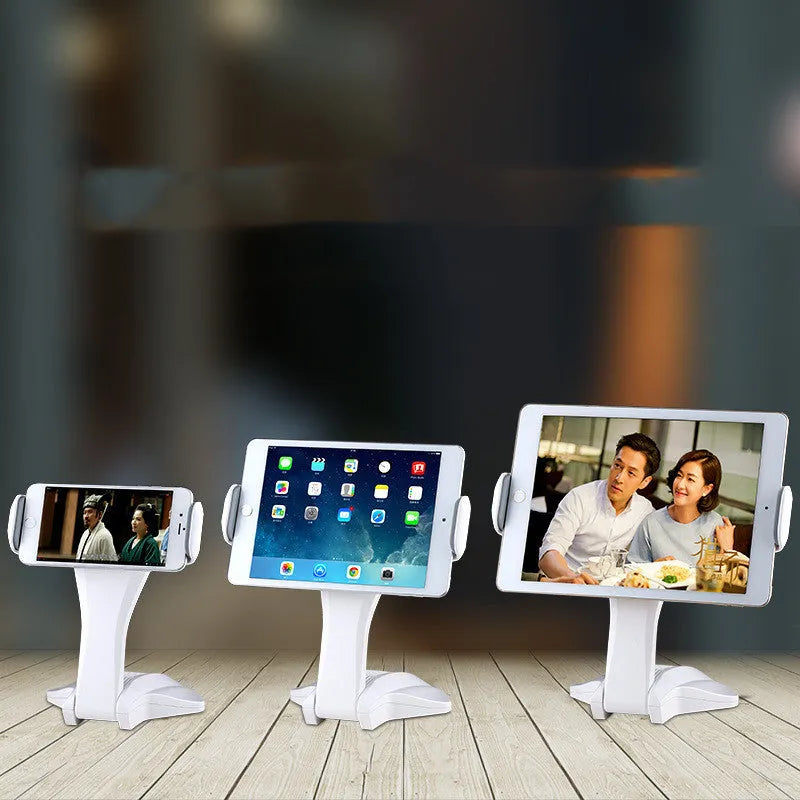 White adjustable tablet stand with metal frame and silicone clip, holding a tablet on a desk.