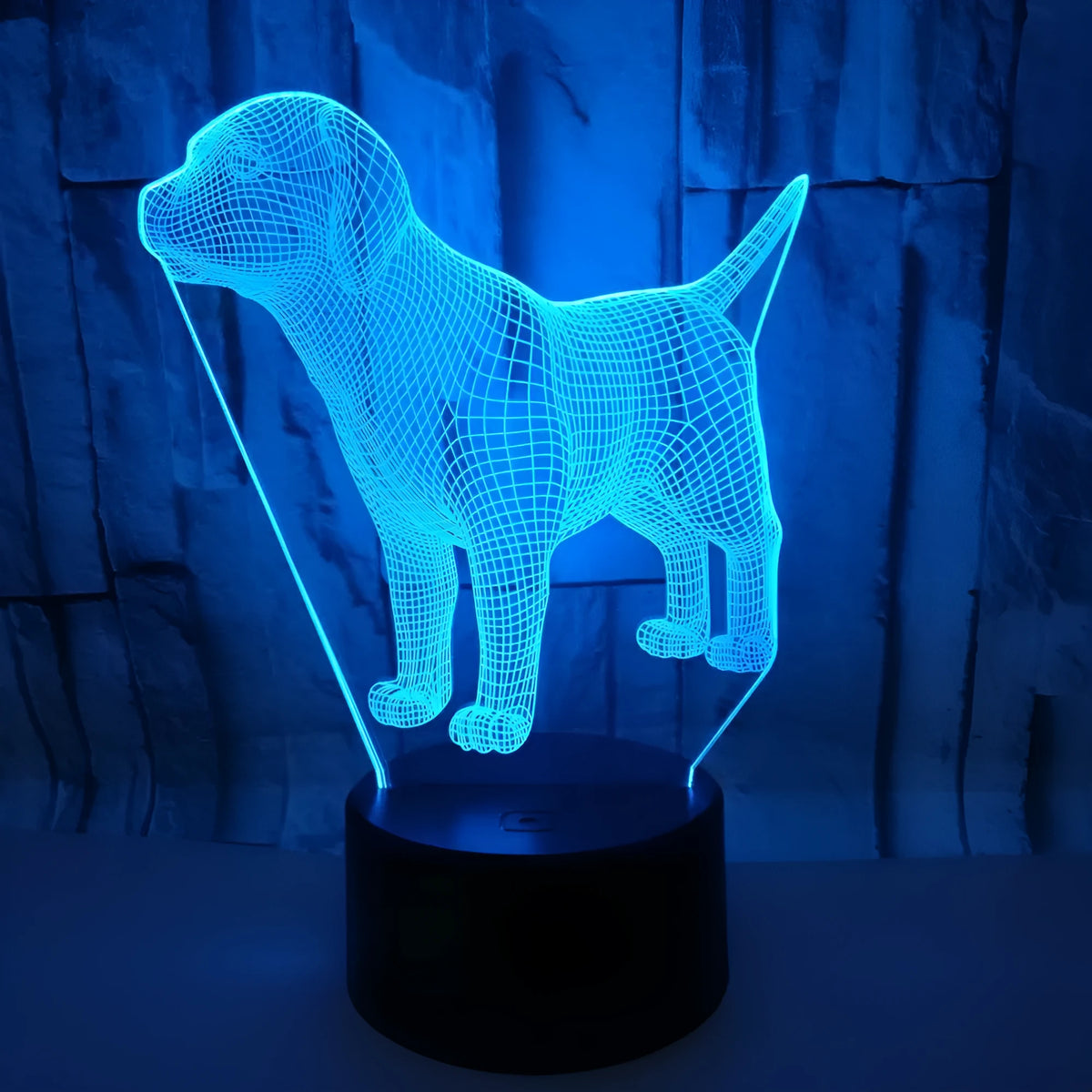 Dog-shaped USB mood lamp showing 7 colours with touch and remote control on a bedside table