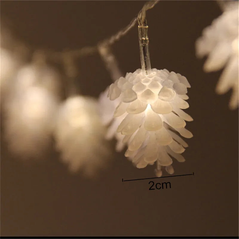 Warm white LED pine cone fairy lights on a string, battery-powered for indoor and outdoor decorative use.