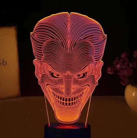A modern 3D LED table lamp with a colourful gradient display, sitting on a square base with a USB cable.