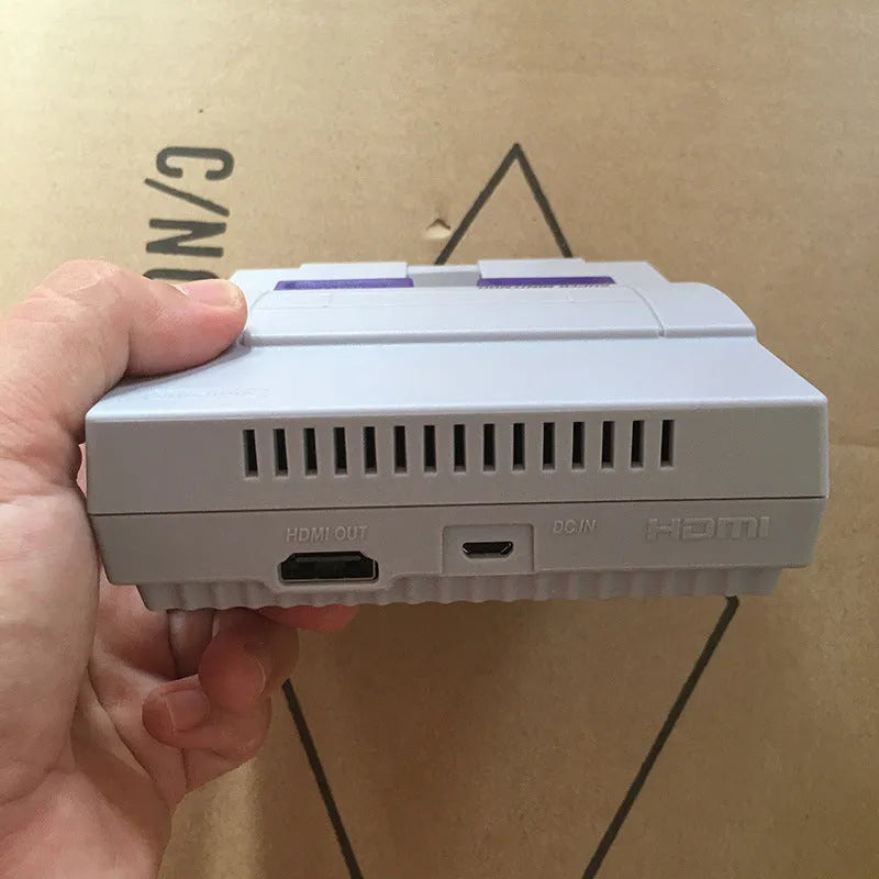 SNES mini game console replica in black with two wired controllers and HDMI cable