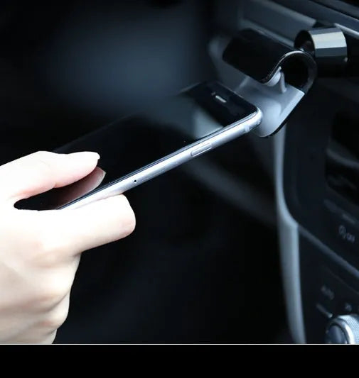 Black universal car phone holder with 360-degree rotation on dashboard