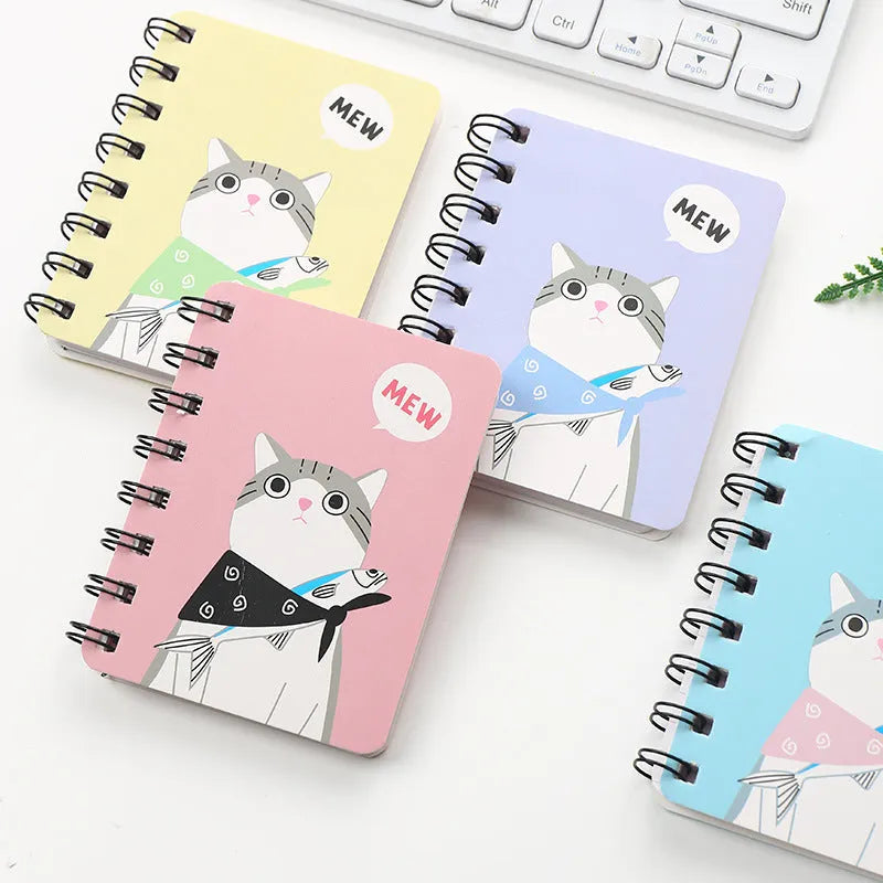 Mini spiral notebook with pen in green, pink, purple, or yellow colours showing 50 pages and 80x105mm size