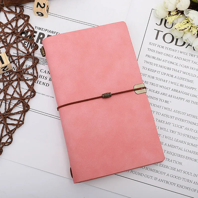 A6 notebook with imitation leather cover in grey, pink or red colours showing cowhide rope binding