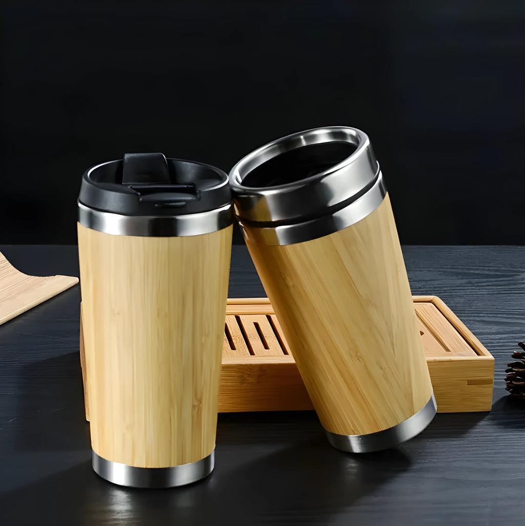 Bamboo coffee cup with double wall insulation, leak-proof lid, and non-slip foam pad on a table